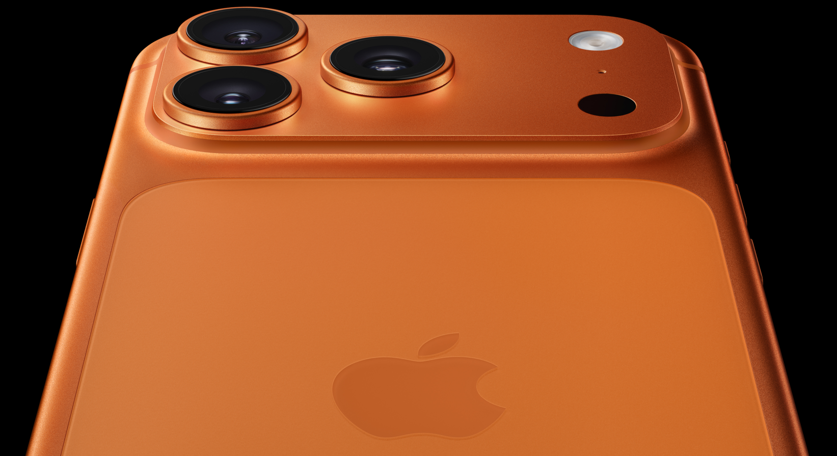 The image showcases the rear view of a smartphone featuring three cameras and a flash, set against a black background. The device is styled in a vibrant orange finish.